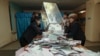 Kazakhstan -- Members of a local election committee empty a ballot box to count votes after a snap parliamentary election in Kyzylorda, March 20, 2016